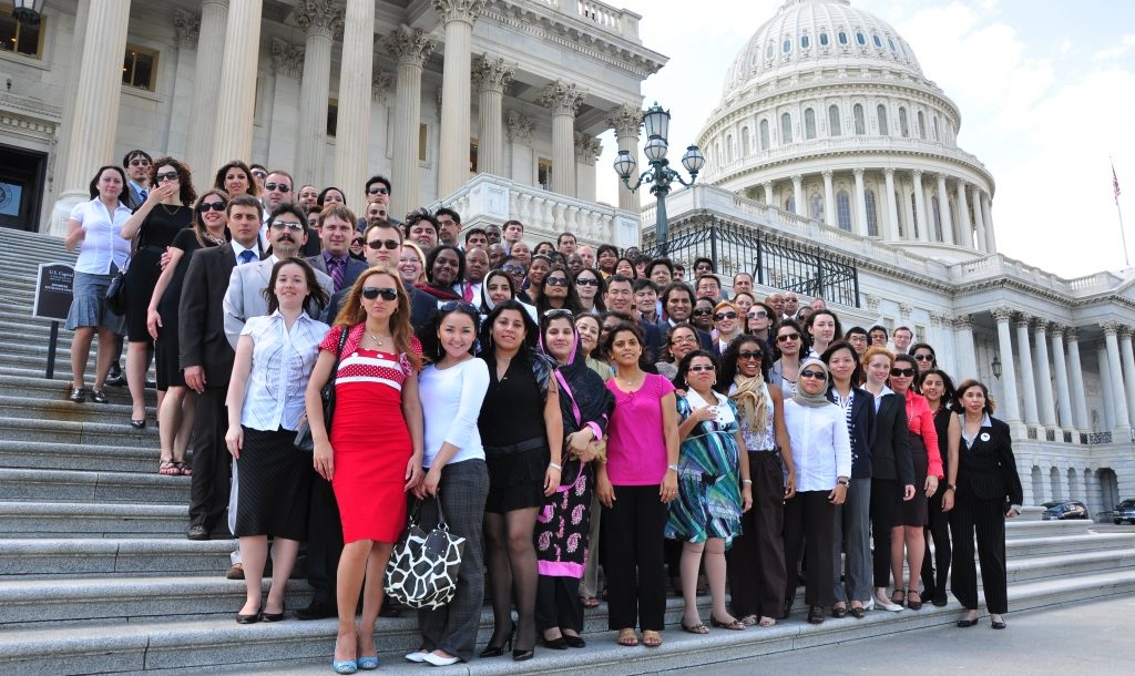 Fellows posing in a large group on the steps of the U.S. Capitol